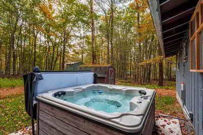 a hot tub in the backyard of a house at Hot Tub Fire Pit Dog Friendly in Pocono Lake