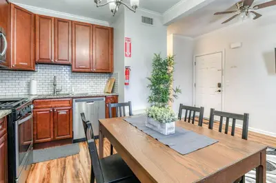 a kitchen with a wooden table and a dining room at Modern 3BR2BA Apartment Minutes to NYC in Jersey City