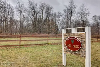 a sign in a field next to a fence at Cozy, Spacious House *New*InTheCommunity+Fire Pit in Tobyhanna