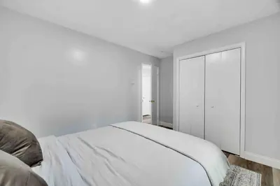 a white bedroom with a bed and a closet at Cozy, Spacious House *New*InTheCommunity+Fire Pit in Tobyhanna