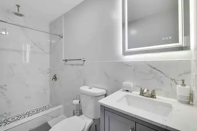 a white bathroom with a toilet and a sink at Cozy, Spacious House *New*InTheCommunity+Fire Pit in Tobyhanna