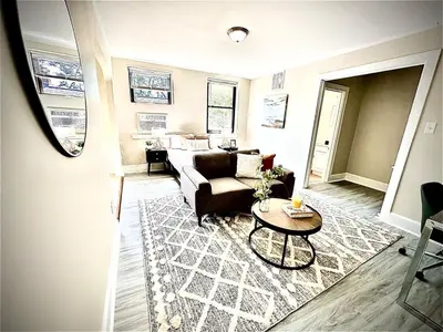 a living room with a couch and a table at Lennox B405 Peaceful & Perfect Studio Apt in Philadelphia