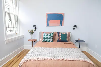 a bedroom with a bed and two windows at The Suites at the Touraine No 109 in Philadelphia