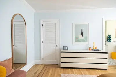a living room with a dresser and a mirror at The Suites at the Touraine No 109 in Philadelphia