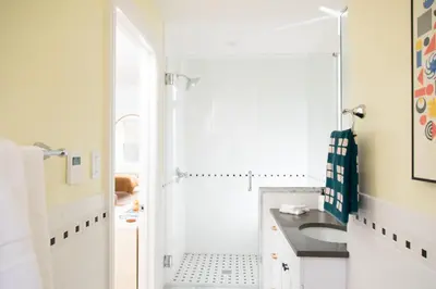 a white bathroom with a sink and a shower at The Suites at the Touraine No 109 in Philadelphia