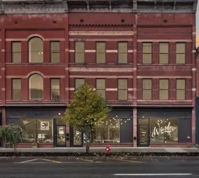 a large red brick building on a city street at Wonder Loft A3 - Main St. Honesdale in Honesdale