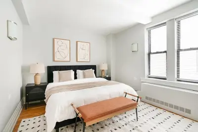 a white bedroom with a large bed and windows at 73-208 New 2BR 2BATH UWS Doorman Gym in New York