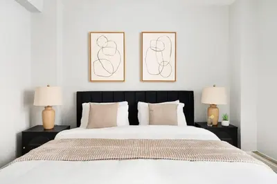 a bedroom with a large white bed with two lamps at 73-208 New 2BR 2BATH UWS Doorman Gym in New York