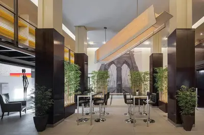 a lobby with tables and chairs and a building at 73-208 New 2BR 2BATH UWS Doorman Gym in New York