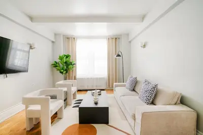 a living room with a couch and a table at 73-208 New 2BR 2BATH UWS Doorman Gym in New York