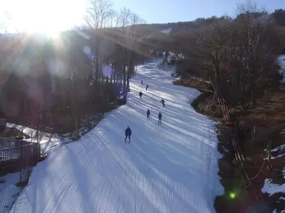 a group of people skiing down a snow covered slope at Nature’s Haven:4 br/2.5 bath, game room & Fire pit in Tobyhanna