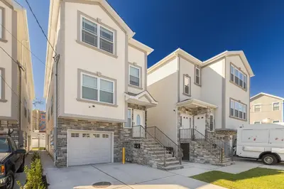 a large white house with a car parked in front of it at Modern one bedroom apartment in Elizabeth