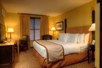 a hotel room with a large bed and a desk at Bear Creek Mountain Resort in Breinigsville