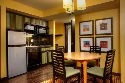 a kitchen and dining room with a table and chairs at Bear Creek Mountain Resort in Breinigsville