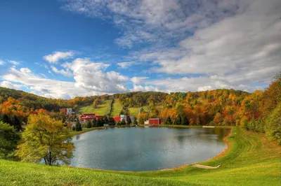 a lake in the middle of a field with trees at Bear Creek Mountain Resort in Breinigsville