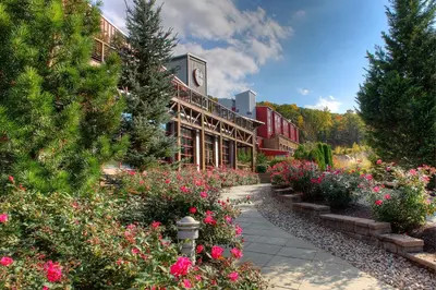 a building with a bunch of flowers in front of it at Bear Creek Mountain Resort in Breinigsville