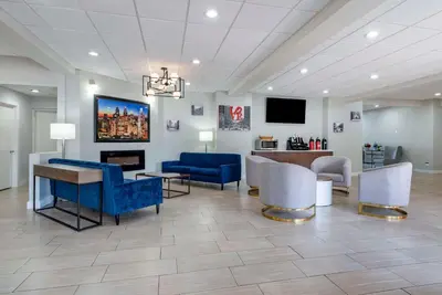 a lobby with blue chairs and a waiting room at Comfort Inn Philadelphia International Airport West in Chester