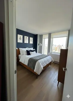a bedroom with a large bed and a window at LES is MORE stunning views in New York