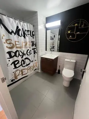a bathroom with a toilet and a sink at LES is MORE stunning views in New York