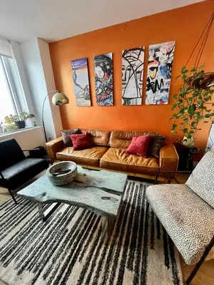 a living room with a couch and a table at LES is MORE stunning views in New York