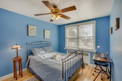 a bedroom with blue walls and a bed with a ceiling fan at Quaint Lansdowne Getaway Near Downtown Philly! in Lansdowne