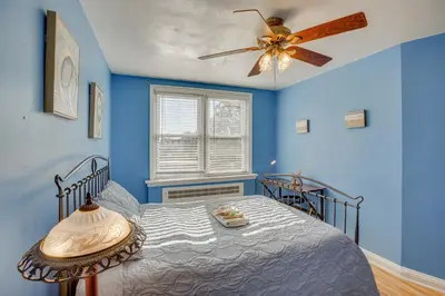 a blue bedroom with a bed and a ceiling fan at Quaint Lansdowne Getaway Near Downtown Philly! in Lansdowne