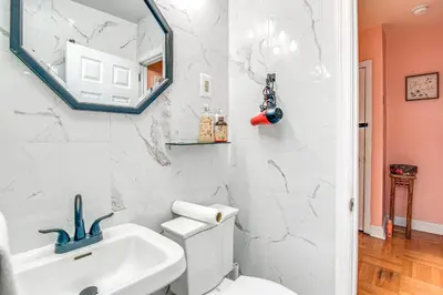 a bathroom with a white sink and a mirror at Quaint Lansdowne Getaway Near Downtown Philly! in Lansdowne