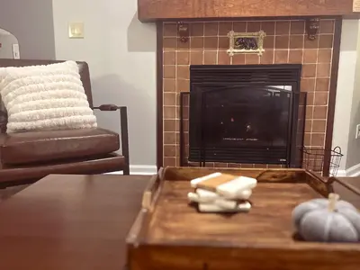 a living room with a fireplace and a pumpkin on a table at Cozy Mountain View Condo in Vernon Township