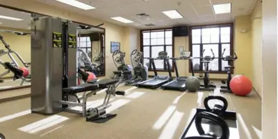 a gym with a lot of tread machines in it at Cozy Mountain View Condo in Vernon Township