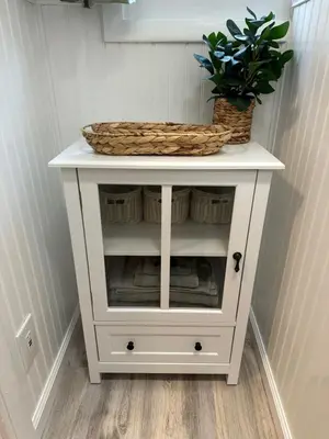 a white cabinet with a potted plant on it at Escape to a Streamside Cabin in the Lower Catskills in Wurtsboro