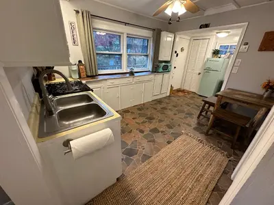 a kitchen with a sink and a counter top at Escape to a Streamside Cabin in the Lower Catskills in Wurtsboro