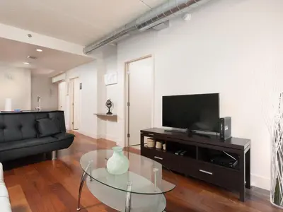 a living room with a glass table and a television at 2BR 1BA Apartment near Rittenhouse Square apts in Philadelphia