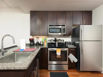 a kitchen with stainless steel appliances and wooden cabinets at 2BR 1BA Apartment near Rittenhouse Square apts in Philadelphia