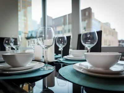 a table with plates and wine glasses on it at 2BR 1BA Apartment near Rittenhouse Square apts in Philadelphia