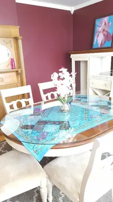 a glass dining table with two white chairs around it at Sunny & Spacious Montclair NJ Apartment in Montclair
