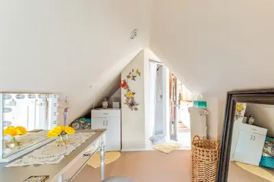 a room with a table with flowers on it at Sunny & Spacious Montclair NJ Apartment in Montclair