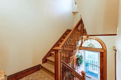 a wooden staircase with a window in a house at Sunny & Spacious Montclair NJ Apartment in Montclair