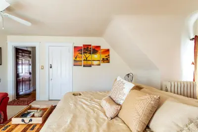 a bedroom with a bed and a painting on the wall at Sunny & Spacious Montclair NJ Apartment in Montclair