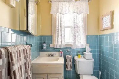 a bathroom with a toilet and a sink and a window at Sunny & Spacious Montclair NJ Apartment in Montclair