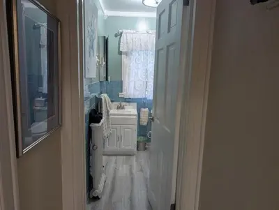 a bathroom with a sink and a toilet and a mirror at Sunny & Spacious Montclair NJ Apartment in Montclair