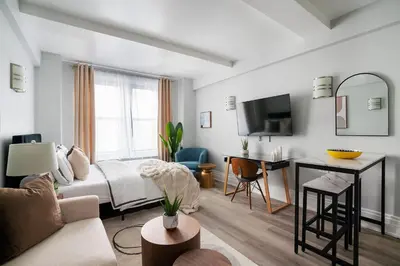 a hotel room with a bed and a desk and a couch at 73-1204 New Studio UWS Doorman Gym in New York