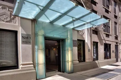 a glass entrance to a building on a city street at 73-1204 New Studio UWS Doorman Gym in New York