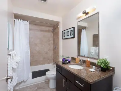 a bathroom with a sink and a toilet and a mirror at Cozy Fully Furnished 2 Bedroom 2 Bathroom Apartment apts in Philadelphia