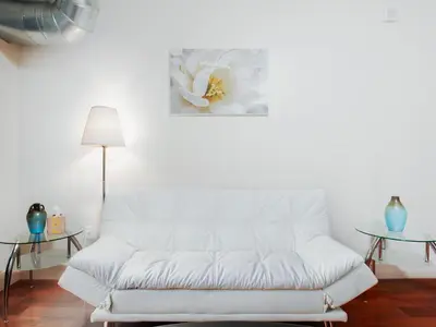 a white couch in a living room with two tables at Cozy Fully Furnished 2 Bedroom 2 Bathroom Apartment apts in Philadelphia