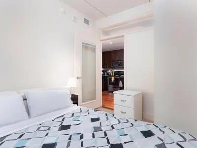 a bedroom with a bed with a checkered floor at Cozy Fully Furnished 2 Bedroom 2 Bathroom Apartment apts in Philadelphia