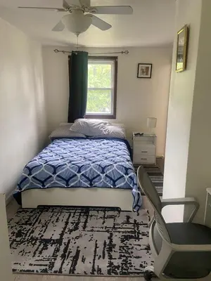 a bedroom with a bed and a window and a chair at cozy room with private bathroom in Arlington