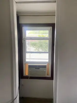 a window with a air conditioner in a room at cozy room with private bathroom in Arlington