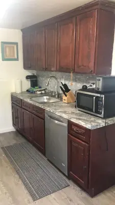 a kitchen with a sink and a microwave at cozy room with private bathroom in Arlington