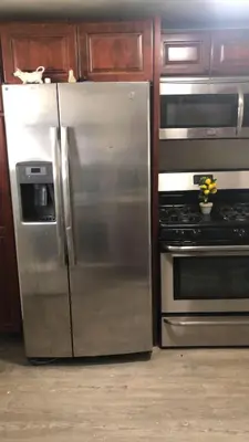 a stainless steel refrigerator and stove in a kitchen at cozy room with private bathroom in Arlington
