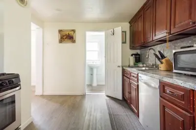 a kitchen with wooden cabinets and a sink at cozy room with private bathroom in Arlington